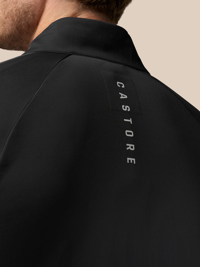 Back of a black Golf Pinnacle jacket showing a stand collar and CASTORE branding along the seam