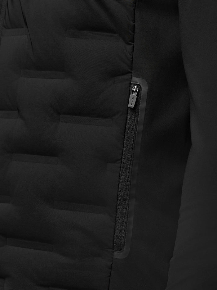 Close-up of black Golf Pinnacle Jacket zipper and water-resistant pocket with Castore pull.