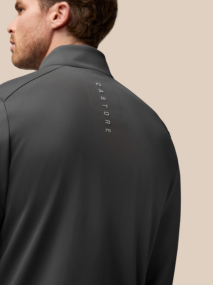Back view of charcoal Garcia Hybrid Jacket showing vertical Castore branding on the upper back.