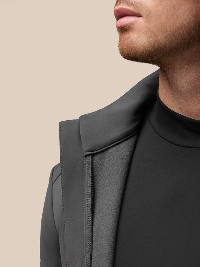 Close up of front zipper area and collar on Garcia Hybrid Jacket with Castore branding on the zipper pull.