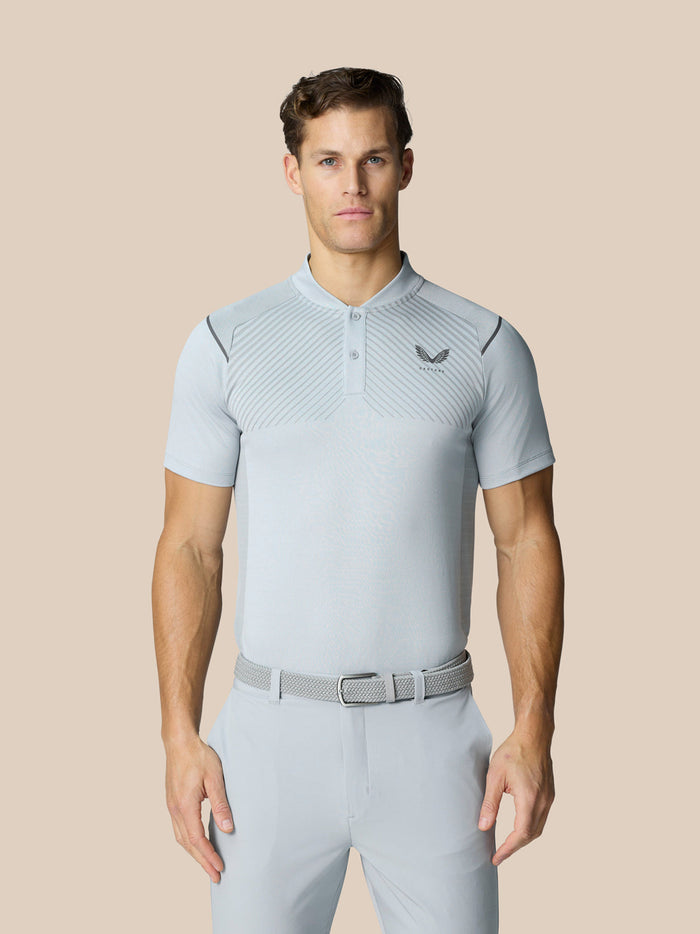 Front view of a male model wearing the Pinnacle Golf LVS Polo in mid grey with engineered diagonal knit lines.
