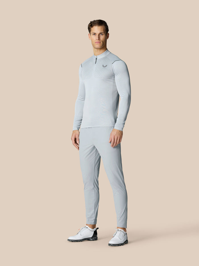 Full length view of a man modeling the Pinnacle LVS 1/4 Zip Top with matching light grey pants