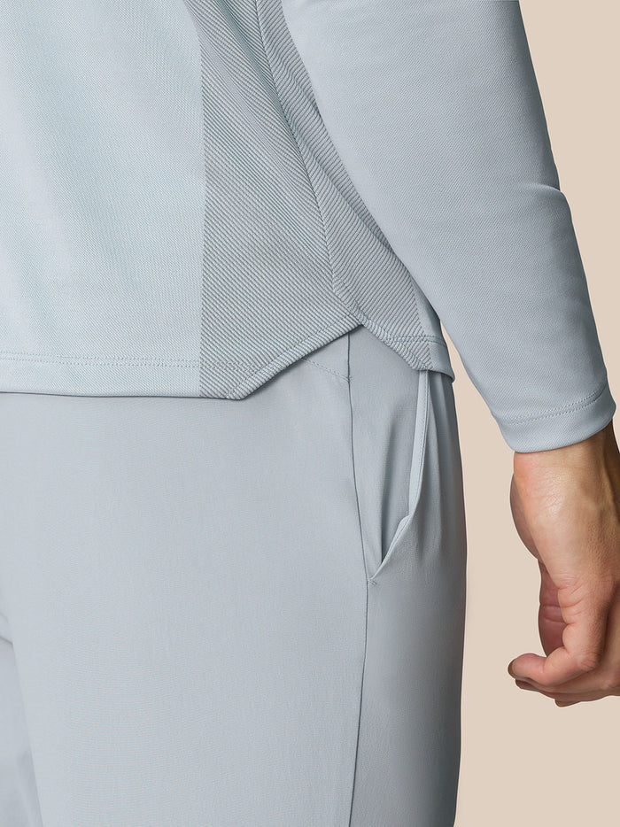 Close-up of the Pinnacle LVS 1/4 Zip Top in mid grey showing side vent and pocket detail.