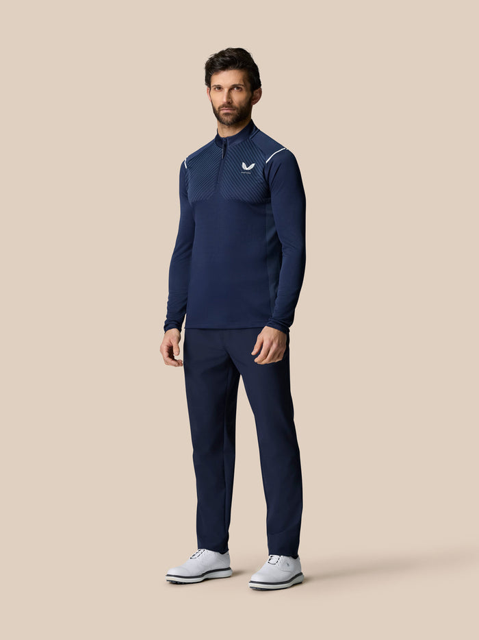 Model wearing navy Pinnacle LVS 1/4 Zip Top with vented chest pattern and subtle white shoulder accents