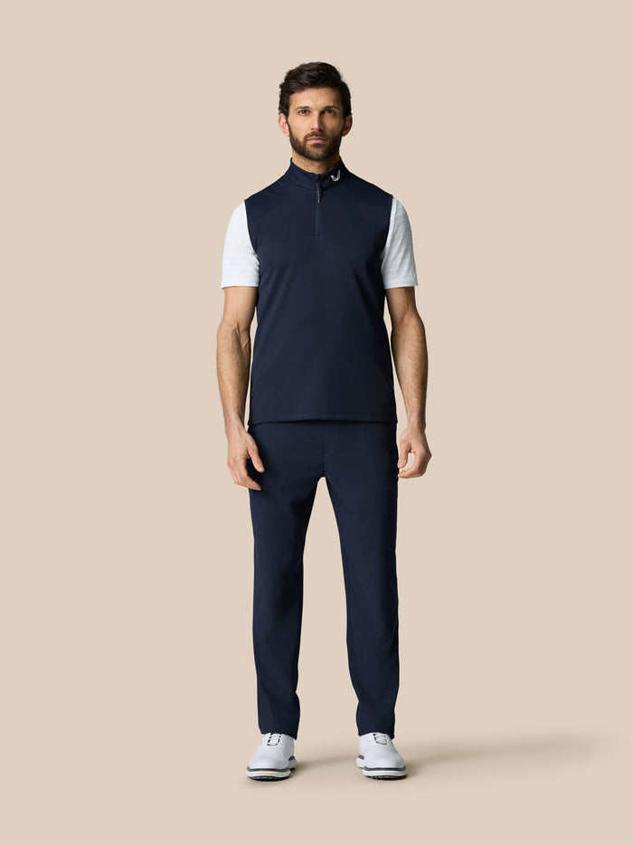 Front view of a male model wearing navy Club 1/2 Zip Gilet over a white T-shirt with navy pants.