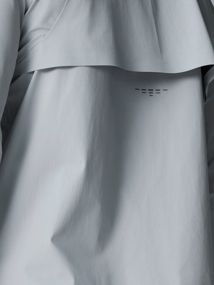 Back panel close-up on mid grey Golf Pinnacle LVS Woven Jacket showing a small vent and curved seam detail.