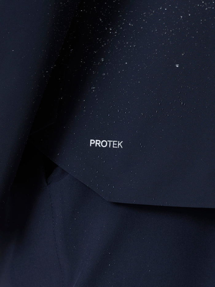 Close-up of water droplets on navy fabric with ProTek lettering on the sleeve