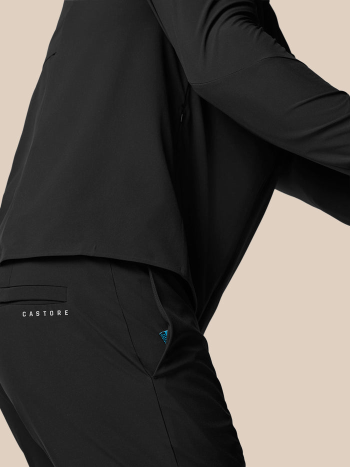 Back view of black winter golf trousers showing back pocket and Castore branding
