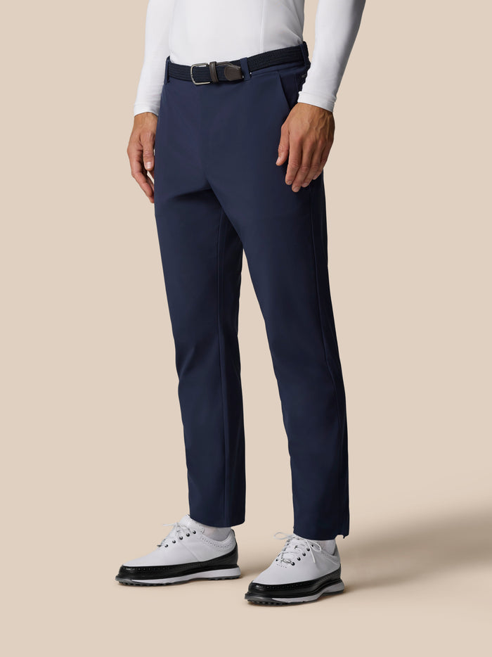 Midnight navy Pinnacle Winter Golf Trousers with belt and white sneakers on model