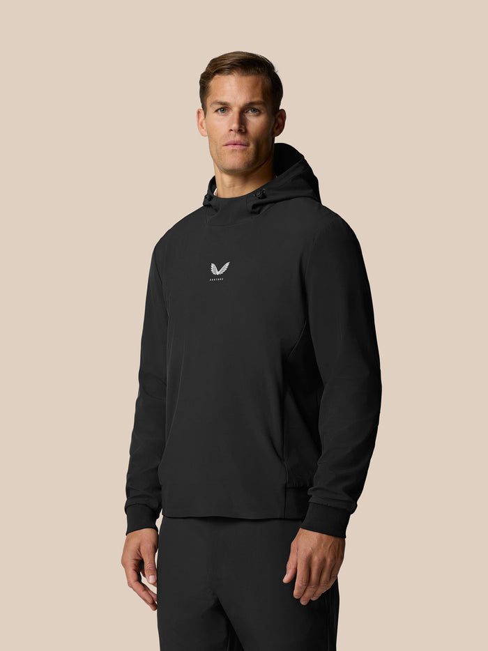 Male model in black Golf Pinnacle Performance Hoodie with center chest logo and hooded pullover style.