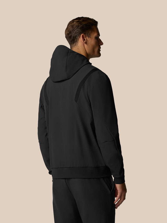 Back view of a man wearing a black Pinnacle Performance Hoodie with the hood up