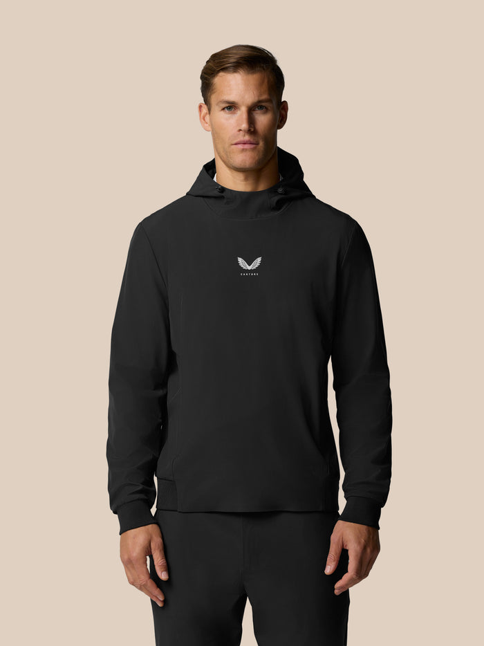 Front view of a man in a black Castore hooded top with a small white logo on the chest