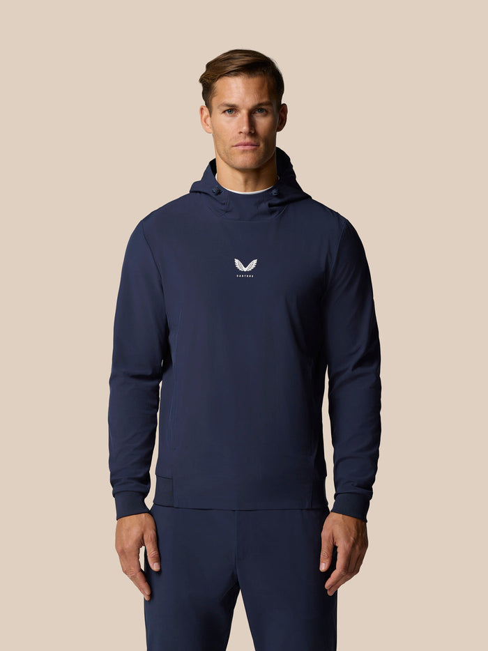 Male model in navy Golf Pinnacle Performance Hoodie with three panel hood and small chest logo