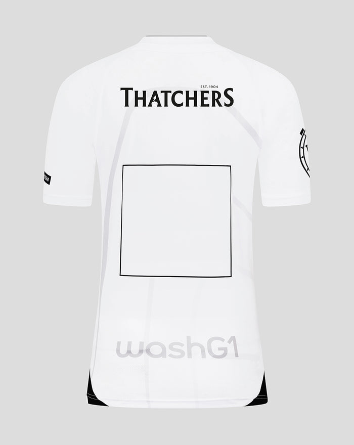 Back view of white Bath Rugby replica shirt with Thatchers logo and a large square graphic.