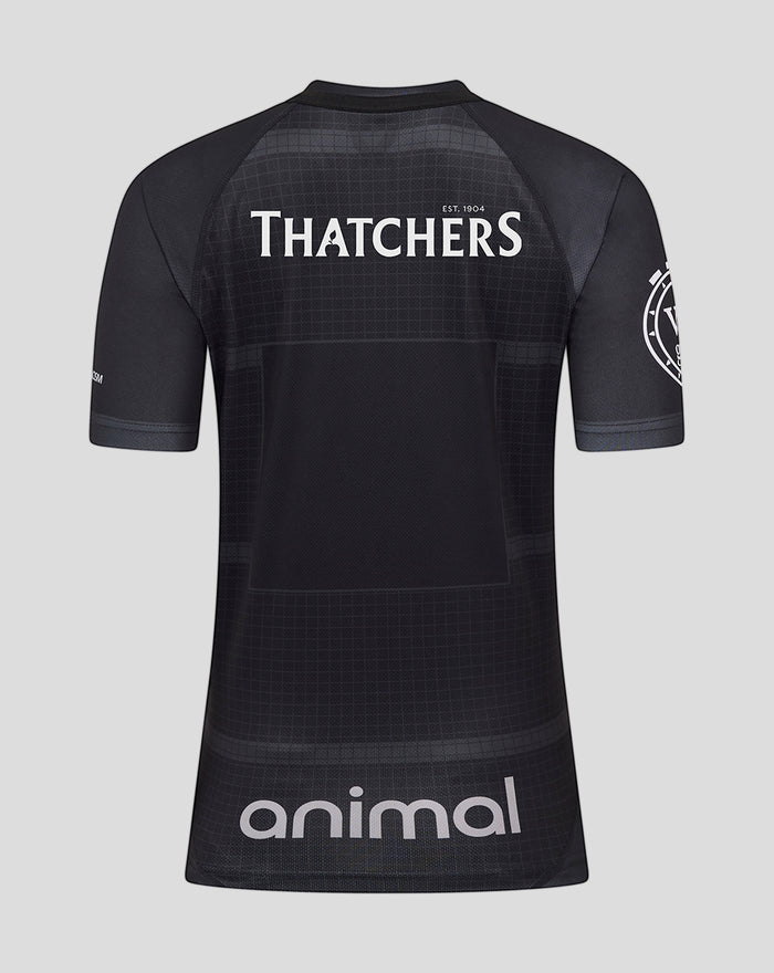 Back view of a black Bath Rugby women's replica shirt with Thatchers logo across the upper back and animal sponsor at the lower back
