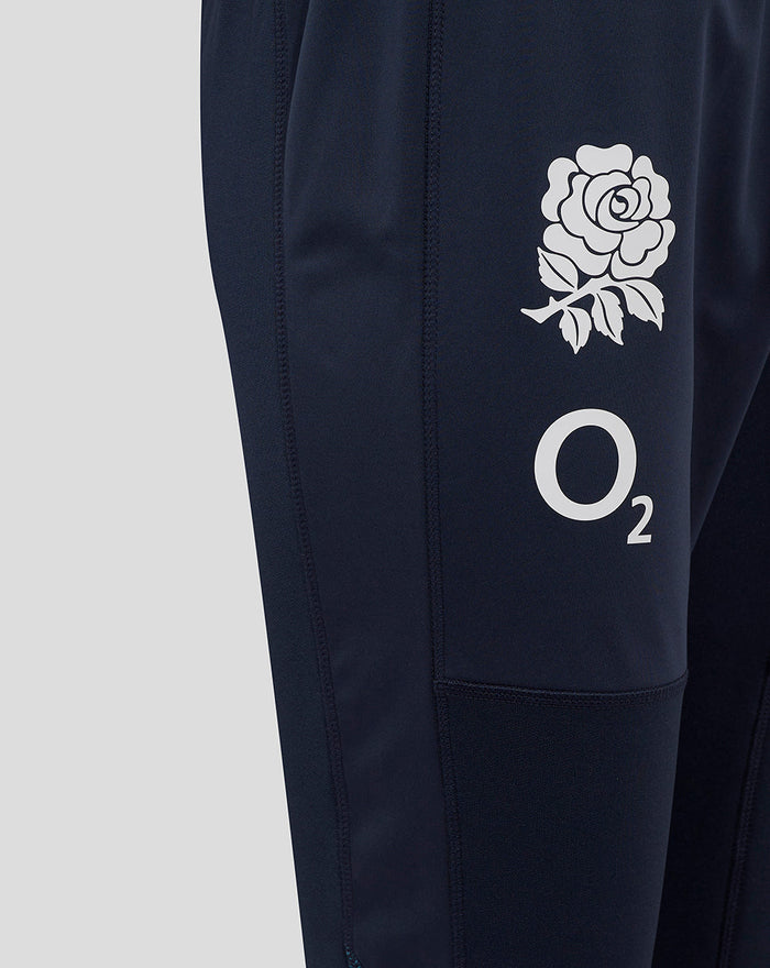 Detail of navy drill pants with rose crest and O2 logo on the right thigh.
