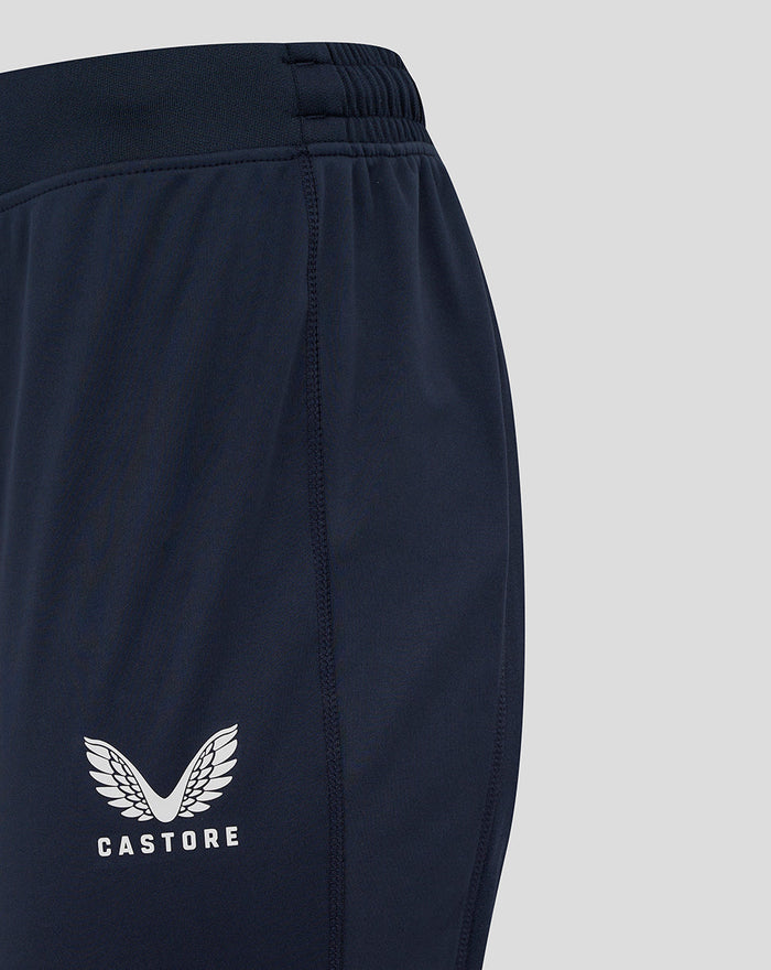 Castore logo on the left thigh of navy England Rugby drill pants in close-up.