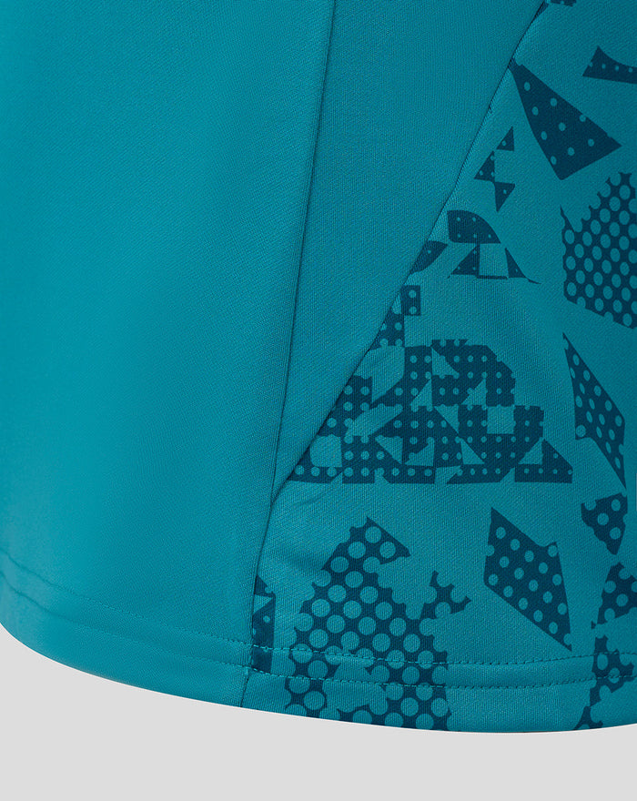 Close-up of storm blue Women's England Rugby midlayer showing abstract sleeve and side panel print.