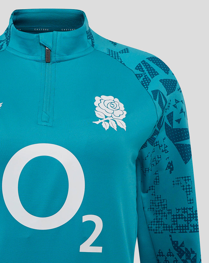 Close up of front chest on storm blue midlayer with white rose crest and O2 logo and patterned sleeve detail.