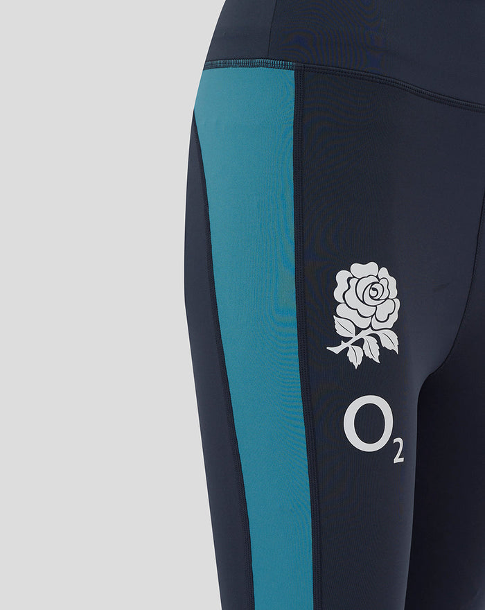 Detail of the right thigh showing the rose crest and O2 logo on navy England Rugby leggings with a teal side panel