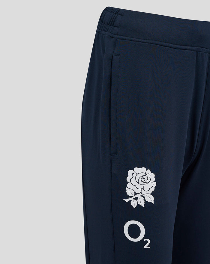 Lower leg view reveals a white rose crest and O2 logo on navy pants.