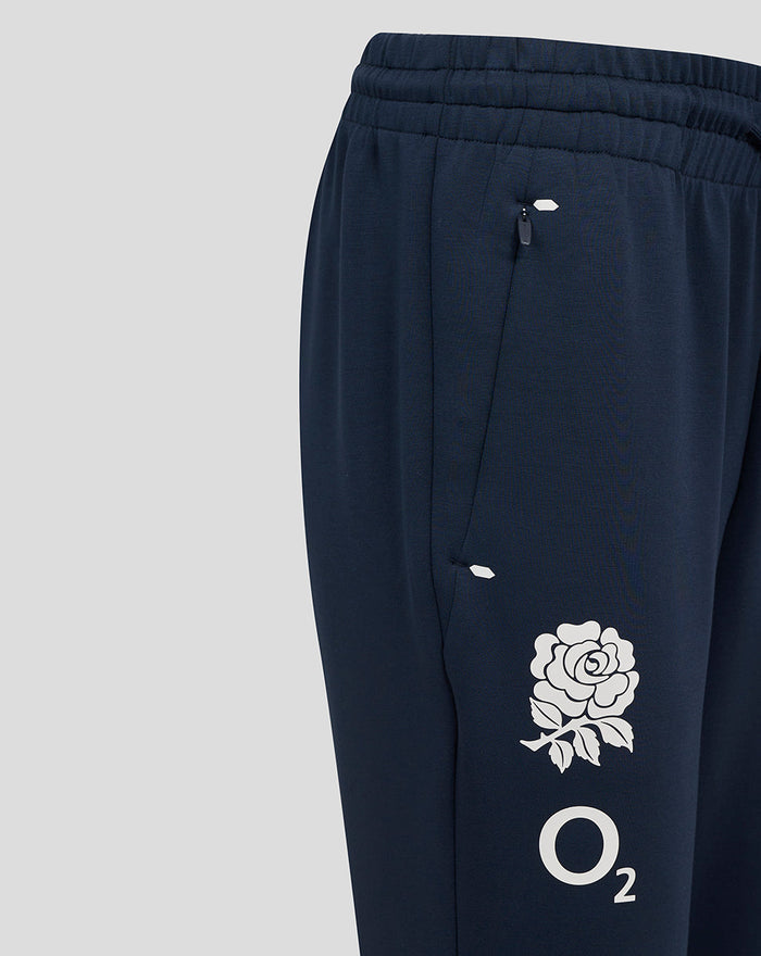 Close-up of side seam showing zip pocket and white rose graphic with O2 on navy pant leg.
