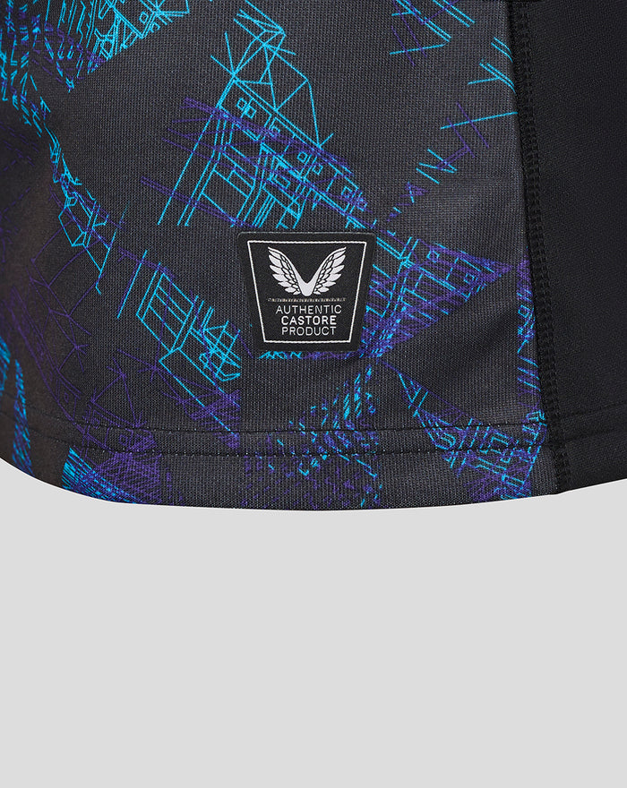 Detail of the shirt fabric with an Authentic Castore Product badge over a blue teal graphic print.
