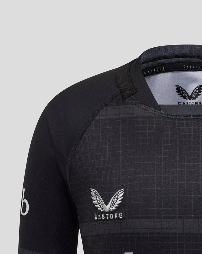 Close up of black Bath Rugby Replica Shirt chest area with grid pattern and Castore wing logo.