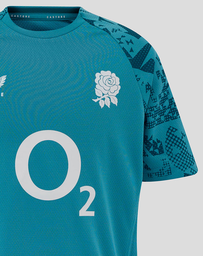 Close-up of chest area on storm blue junior rugby tee showing rose crest and large O2 logo at center