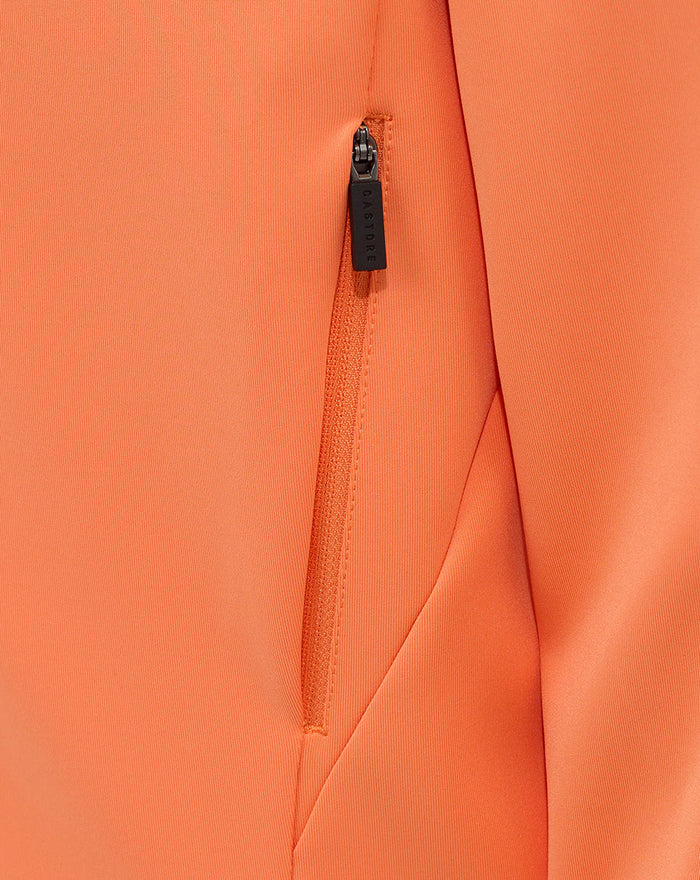 Vertical zip pocket on the melon hoodie with Castore branded zipper pull.
