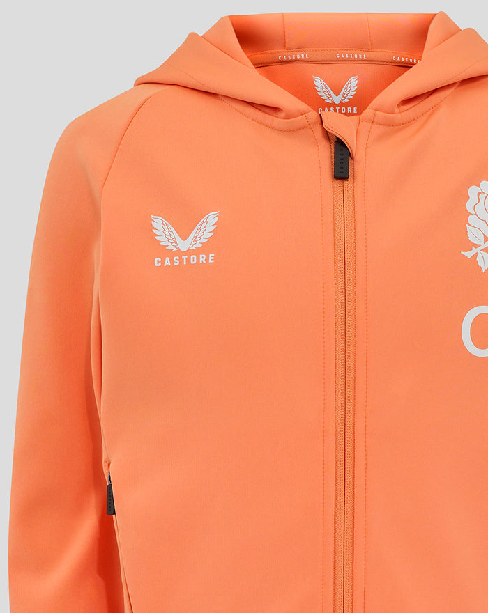 Close up of the melon hoodie chest with Castore logo on the left and rose crest on the right, zipper in the center.