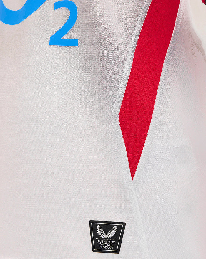 White junior England Rugby home shirt with geometric front pattern and red side panel.