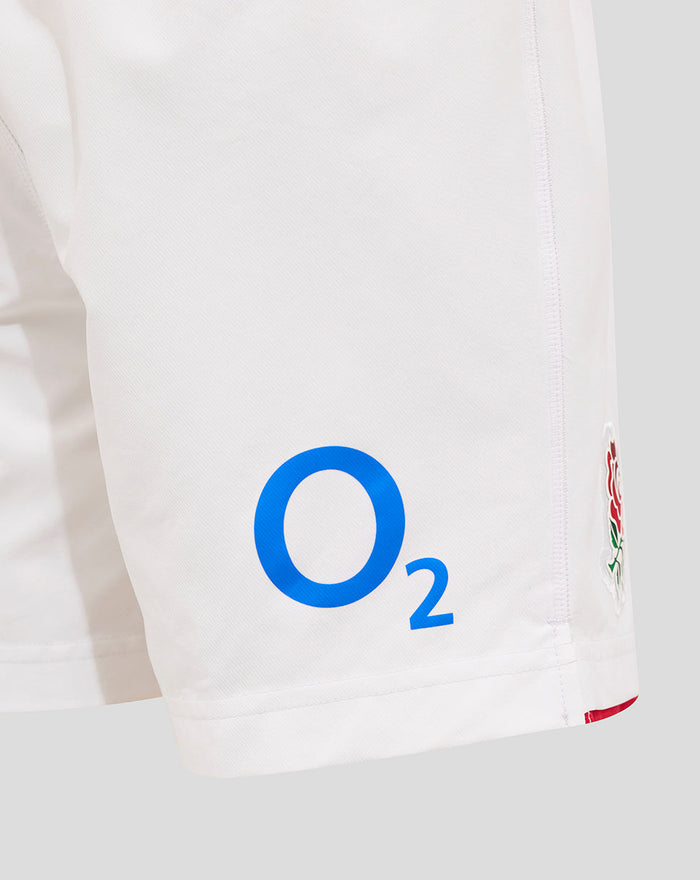 White Junior England Rugby Home Shorts with blue O2 logo on the back leg and a rose crest patch on the side.