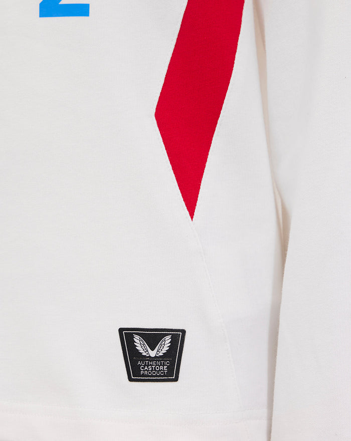 Lower front of white rugby shirt with bold blue O2 graphic, red side panel and small Castore product badge.