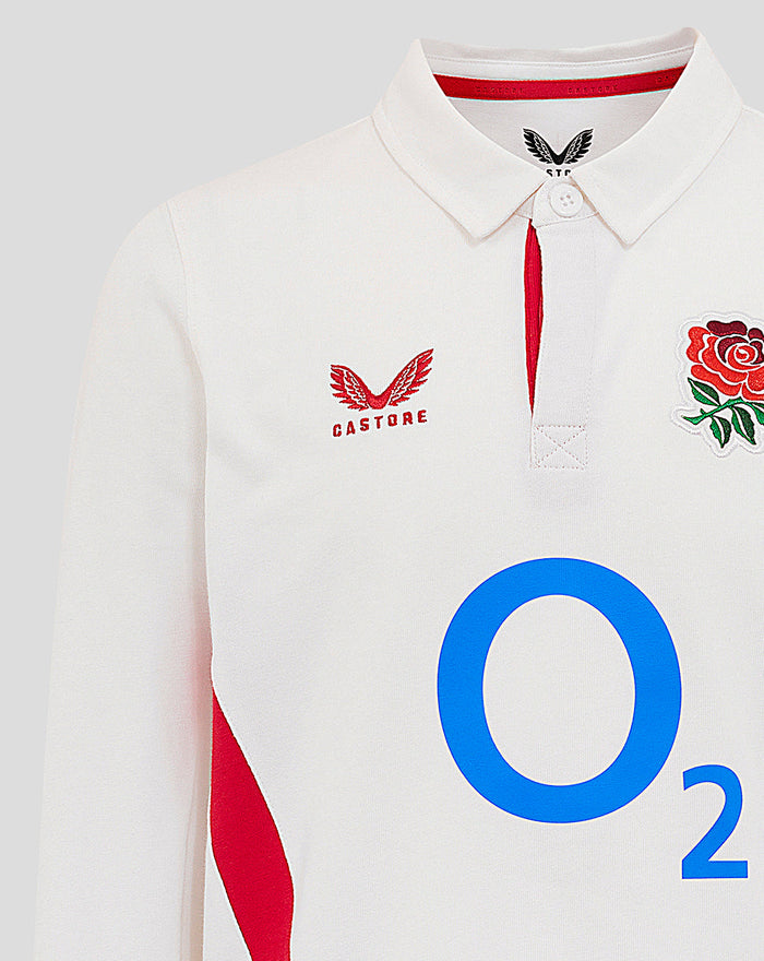 Close-up of white junior England rugby shirt showing Castore logo on left chest, rose crest on right chest and O2 branding on front.