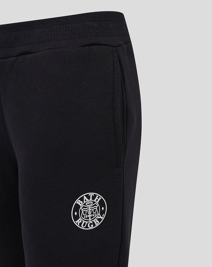 Close up of black Junior 24/25 Core Jogger showing Bath Rugby crest on the thigh