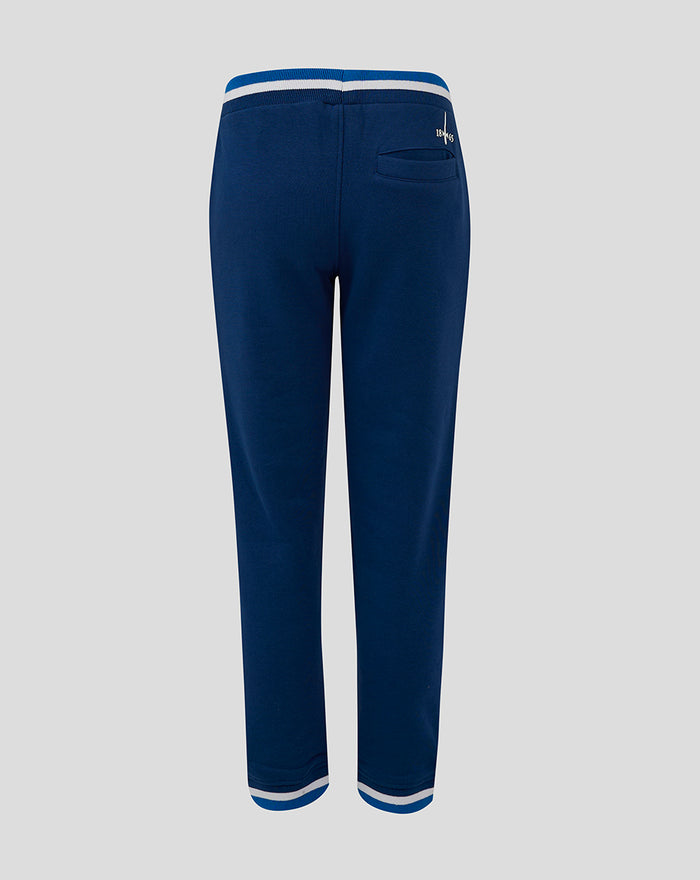 Rear view of navy junior jogger with striped cuffs and left leg logo patch