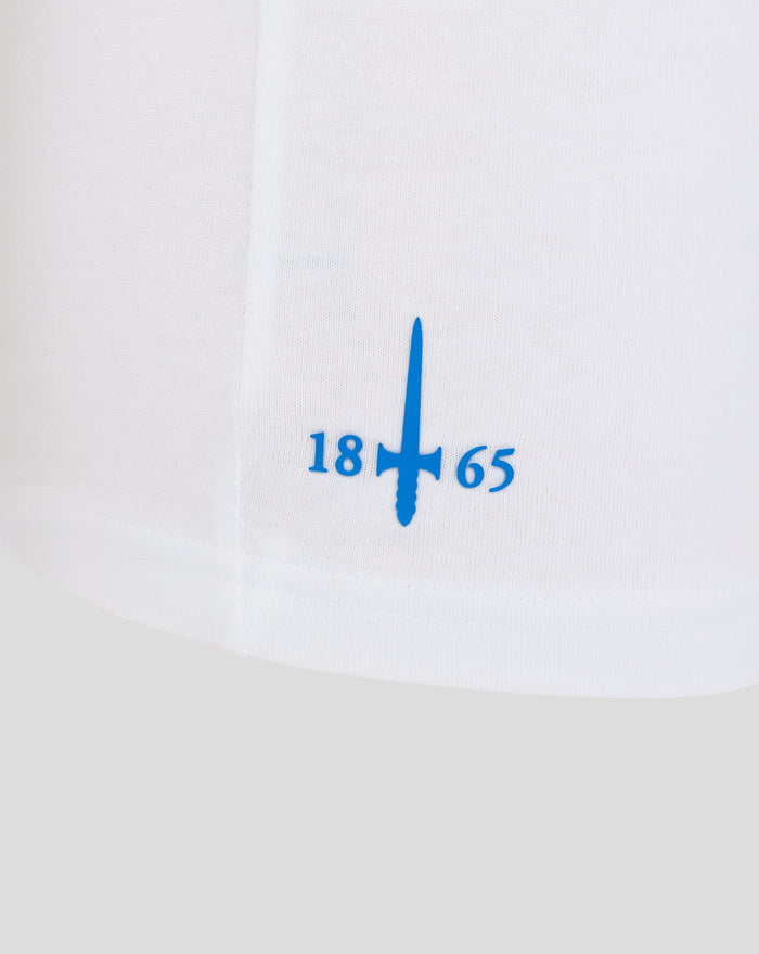 Close-up of white cotton T shirt showing a blue printed graphic with a vertical emblem and numbers 18 65.