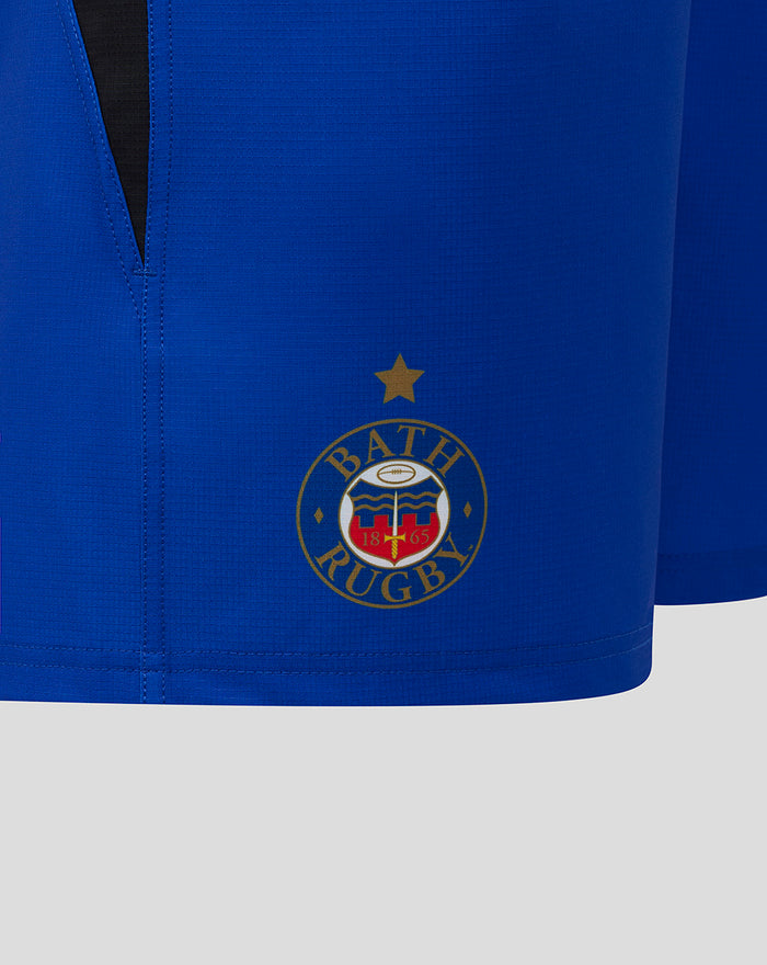 Close-up of the Bath Rugby crest on royal blue shorts near the hem.