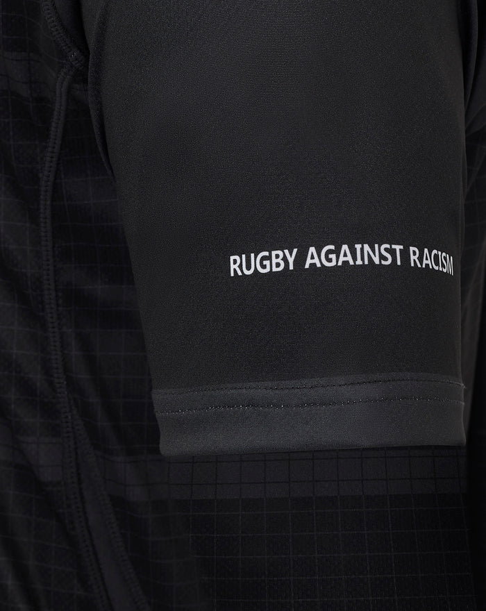 Close up of a black Bath Rugby jersey sleeve with Rugby Against Racism slogan