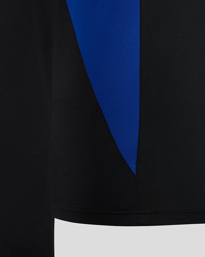 Close-up of Bath Rugby training midlayer fabric with black base and bold blue diagonal panel.