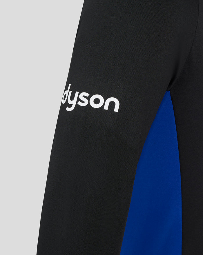 Close-up of sleeve with white Dyson logo on black fabric and blue side panel.
