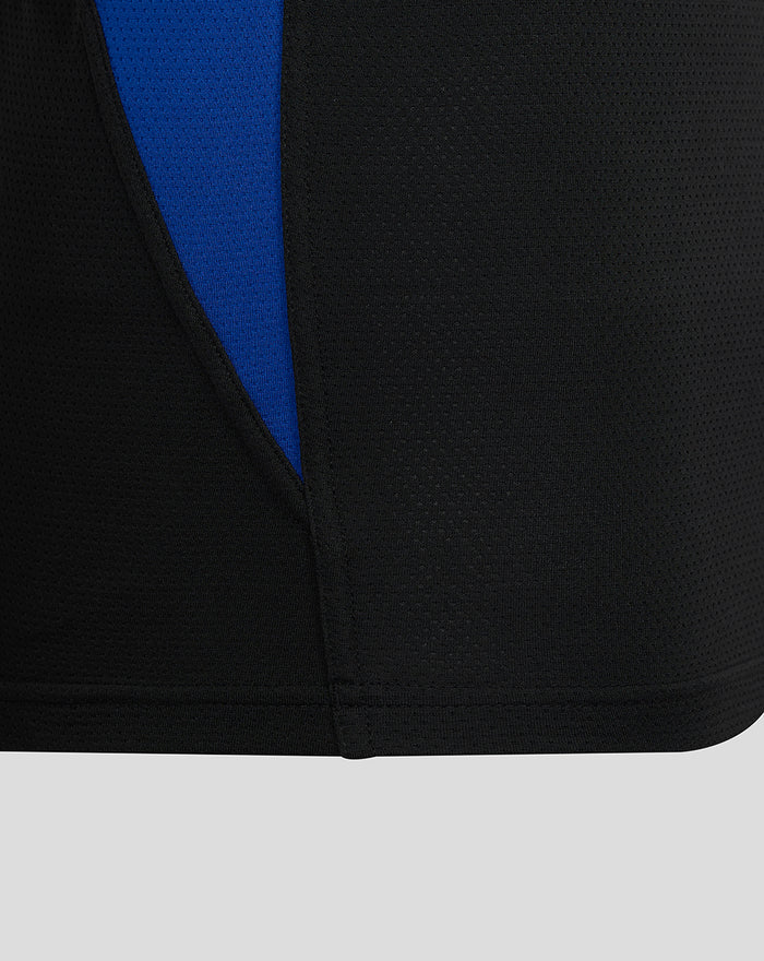Close-up of black mesh fabric with a blue underpanel peeking from the side seam