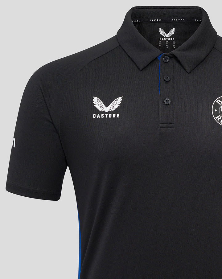 Close up of black Bath Rugby Poly Polo showing Bath Rugby crest and Castore logo with blue trim along the placket.