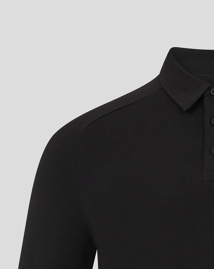 Close-up of the black polo showing shoulder seam and the collar with buttoned placket.
