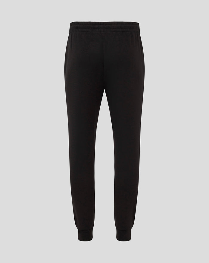 Back view of men's black travel knit pant with elastic waistband and cuffed ankles.