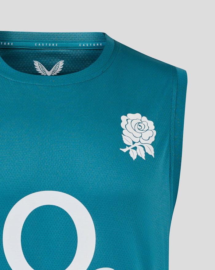 Close up of teal sleeveless rugby top neck area showing Castore branding and partial white floral design on chest