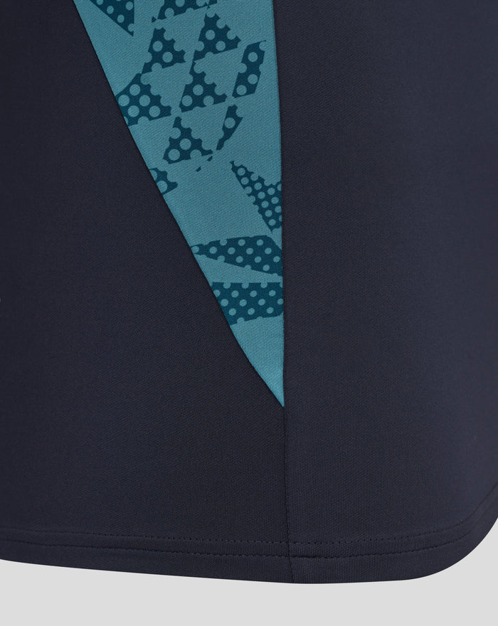 Close up of inkwell navy midlayer with teal abstract print panel along the front and curved hem.