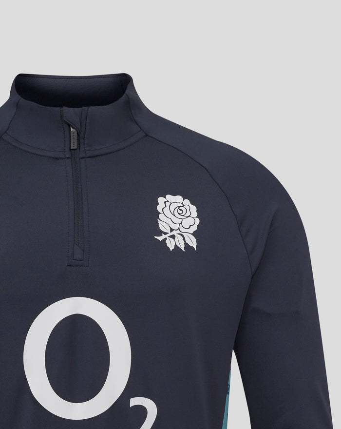 Navy inkwell funnel neck with centre quarter zip and Castore zipper pull; white floral crest on chest.