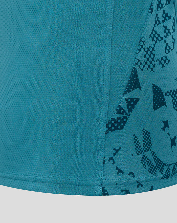 Close up of storm blue sleeveless rugby singlet fabric with an abstract pattern on the side panel and stitched hem